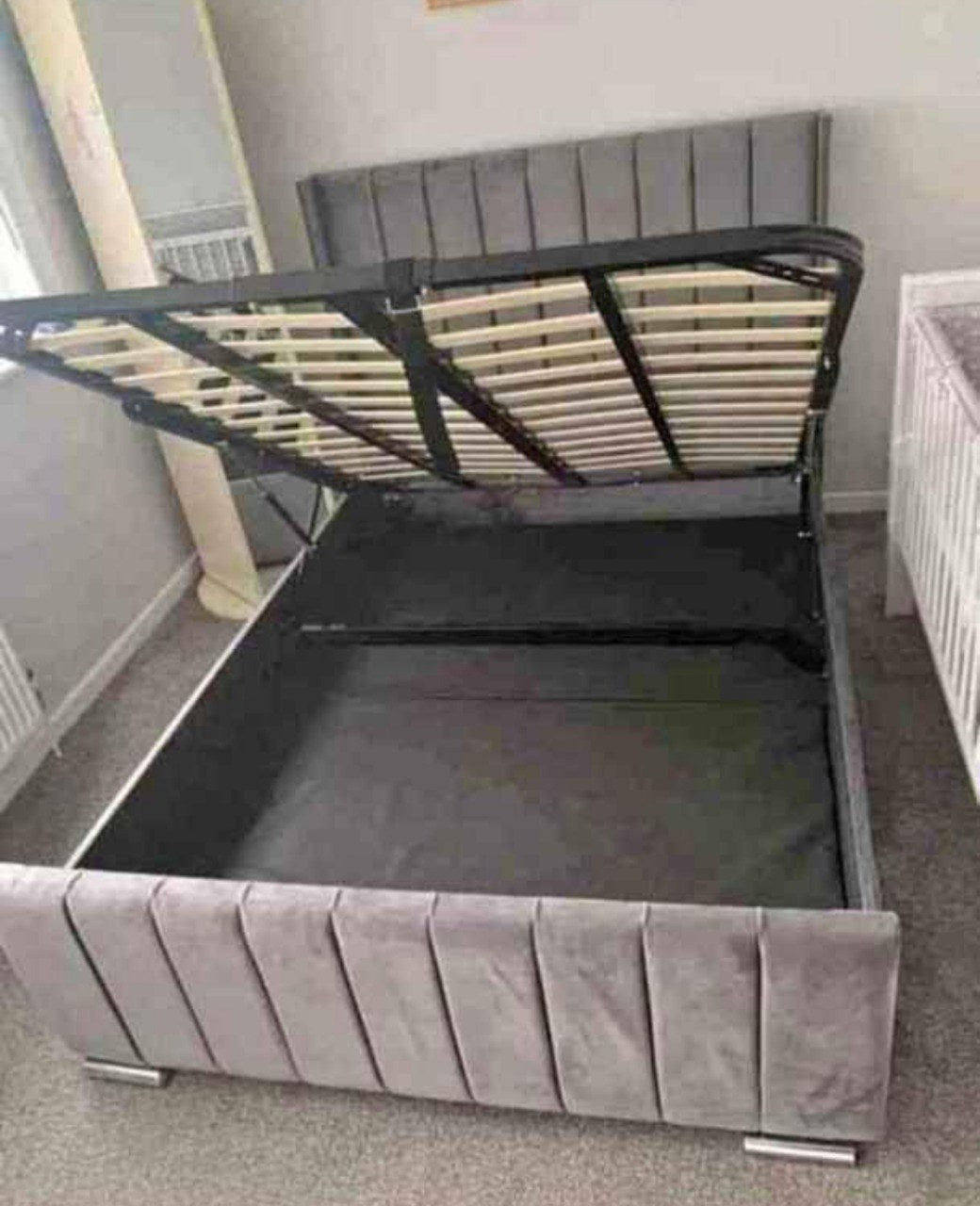 Bumper Panel Bed with optional gas-lift ottoman storage base raised to show storage space