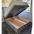 Grey Divan Ottoman bed with gas-lift storage base lifted