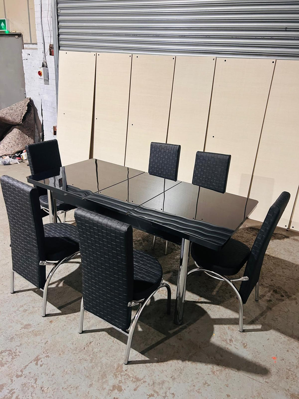 Extendable Glass Dining Table with 6 Chairs in full black from Kensley Home