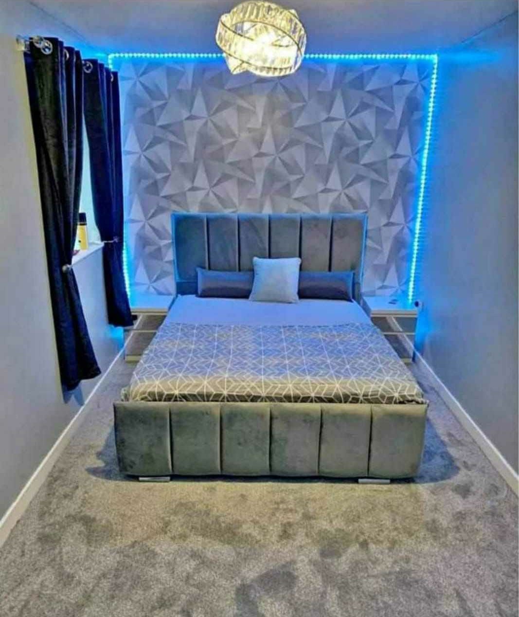 Grey velvet Panel Line Bed in a bedroom with ambient blue lighting