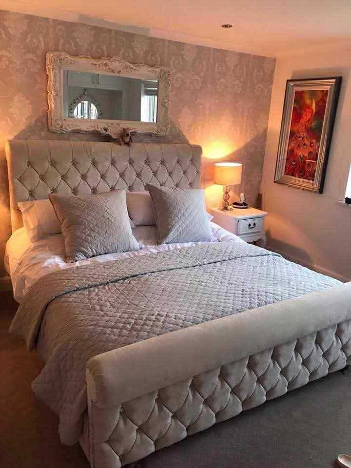 Silver crushed velvet chesterfield Sleigh Bed in a cosy bedroom