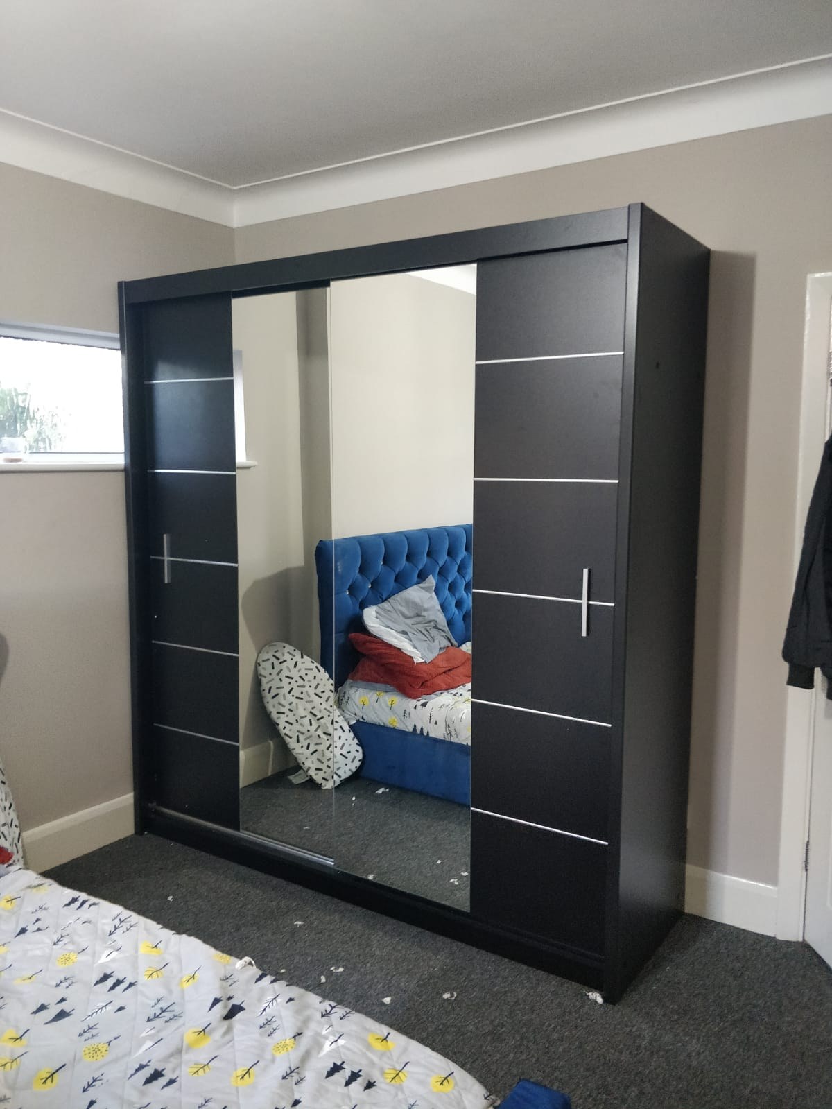 Black sliding door wardrobe with mirror and silver strip detail