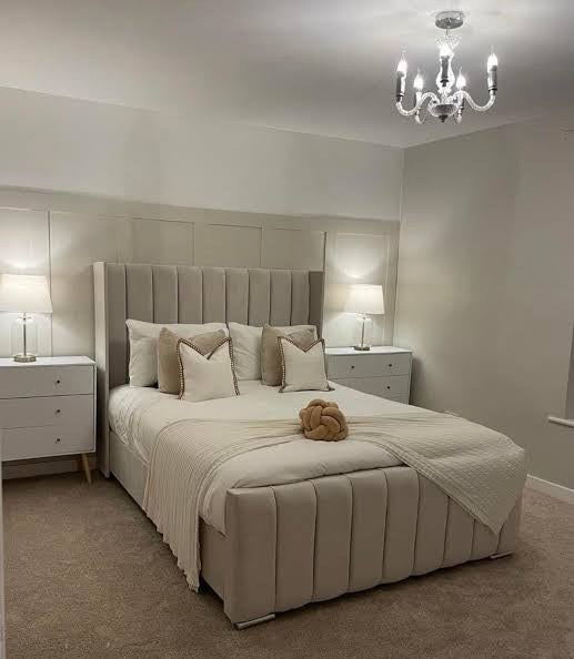 Light grey velvet Wingline Panel Bed styled with neutral bedding