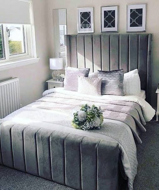 Grey velvet Wingline Panel Bed with panelled footboard and floral centrepiece